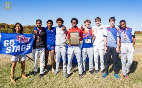 Members of the DeMatha cross country team celebrate after edging Gonzaga to win the program’s fourth conference title. Courtesy of Antoine Keels 