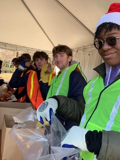 Johnathan Mack (in Santa hat)  and fellow students from DeMatha Catholic High School sort and package produce for the Dec. 20, 2022, food distribution.
Courtesy of the City of Hyattsville