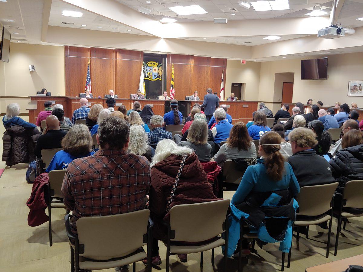 a crowd at the Laurel city council meeting