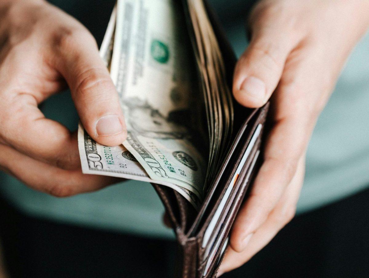 torso of someone opening a wallet