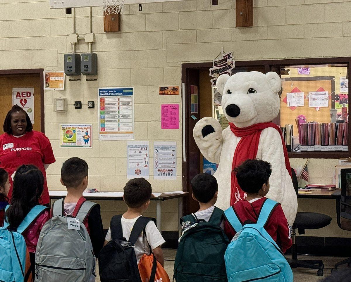 The Coca-Cola Polar Bear talks to Hollywood Elementary  School students before giving each one a new pair of shoes. Photo by MACKENZIE PRINCE