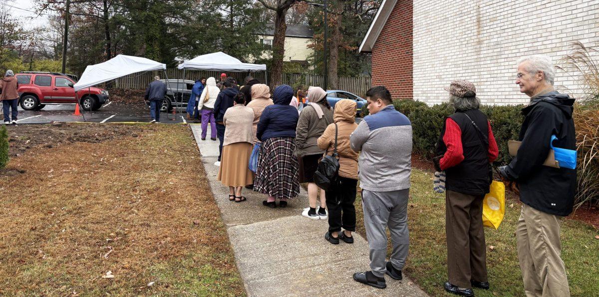 Dozens of people stand in line at the College Park Community Food Bank the Saturday before Thanksgiving to pick up free turkeys during the nonprofit's annual giveaway. Photo by SAMMY LIU