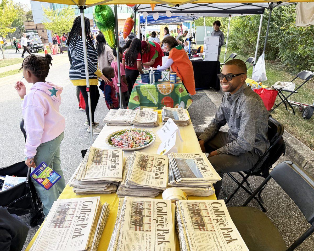 College Park Here & Now Associate Editor Jalen Wade staffs a booth at College Park Day in October. Photo by SHARON O'MALLEY