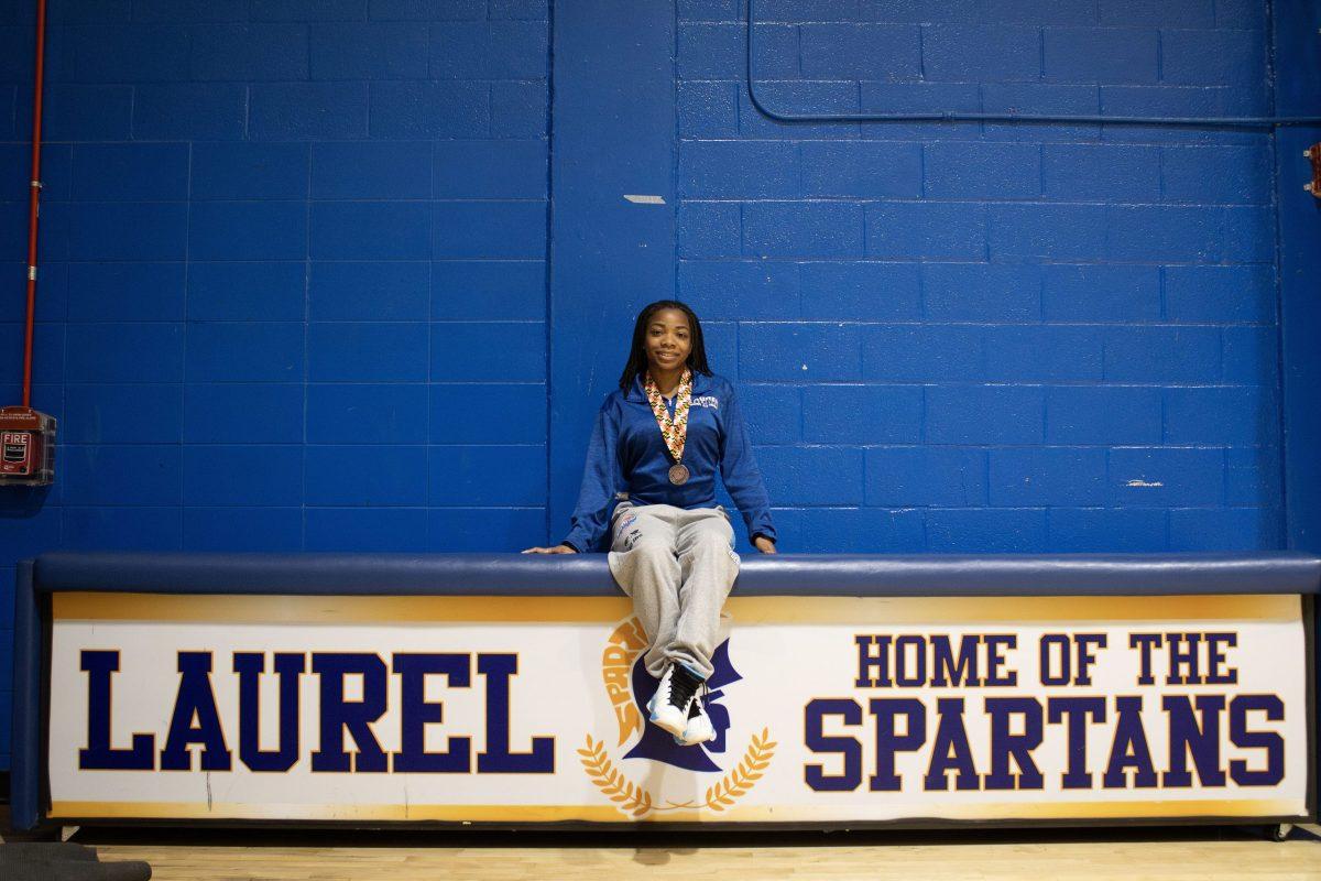 Olivia Crosby poses with her third-place state championship medal March 18 in Laurel High School’s gymnasium.