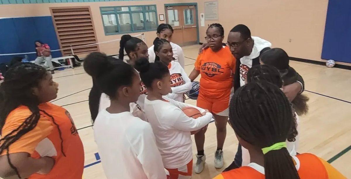 James Agbai going over the game plan with players before the game at the DiPietro Community Center. 