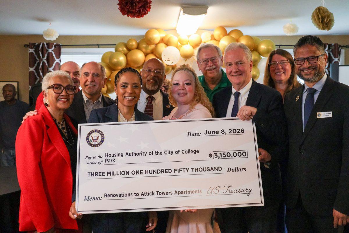 Federal, state, county and city officials attended a June 8 event at Attick Towers, where they presented a check for $3.15 million for renovations to the 54-year-old public housing apartment building. Shown, from left to right: House Authority of College Park Chair Arelis Pérez; Vice Chair Bob Catlin; Prince George’s County Councilmember Eric Olson (District 3); U.S. Sen. Angela Alsobrooks; U.S. Rep. Glenn Ivey (District 4); Michelle Crittenden-Johnson, Housing Authority CEO; state Sen. Jim Rosapepe (District 21); U.S. Sen. Chris Van Hollen; College Park City Councilmember Kelly Jordan (District 2); College Park Mayor Fazlul Kabir. Photo by JONATHAN PETER BELLING
