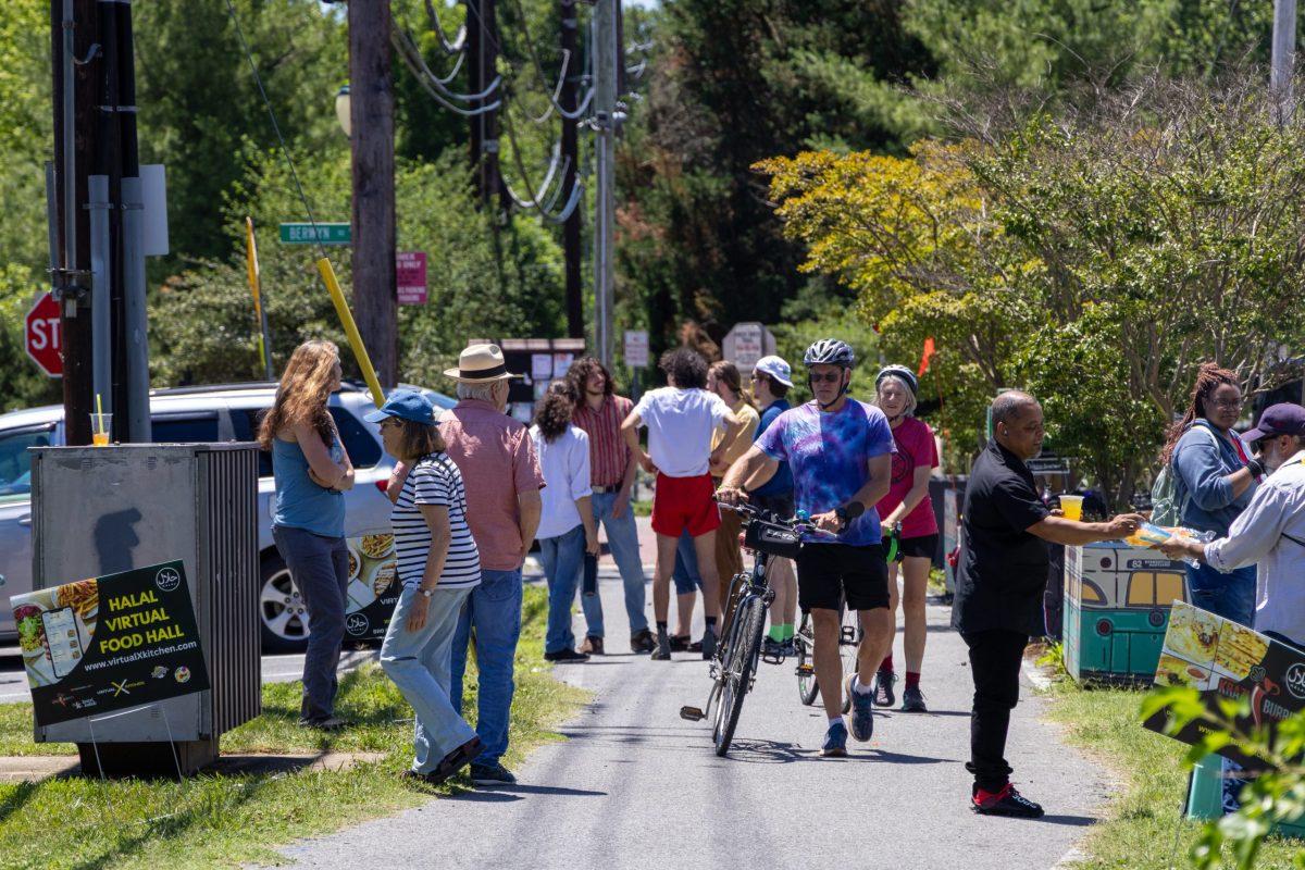 People walk, talk and chat at the Berwyn neighborhood hub in College Park during Trolley Trail Day on June 13. Photo by JONATHAN PETER BELLING