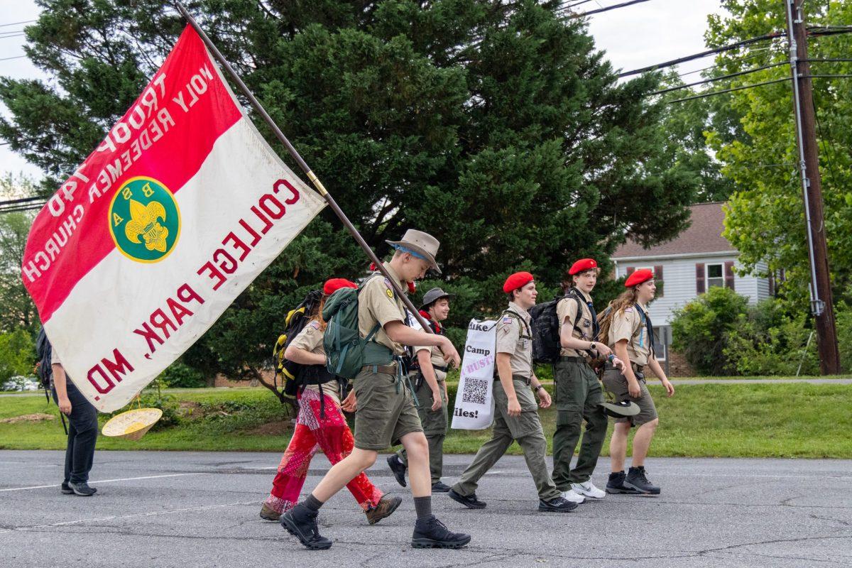 Scouts from BSA Troop 740 begin their 208-mile hike from College Park to Goshen Scout Camp in Virginia. Holding flag, Lazarus Kovarik. Photo by JONATHAN PETER BELLING